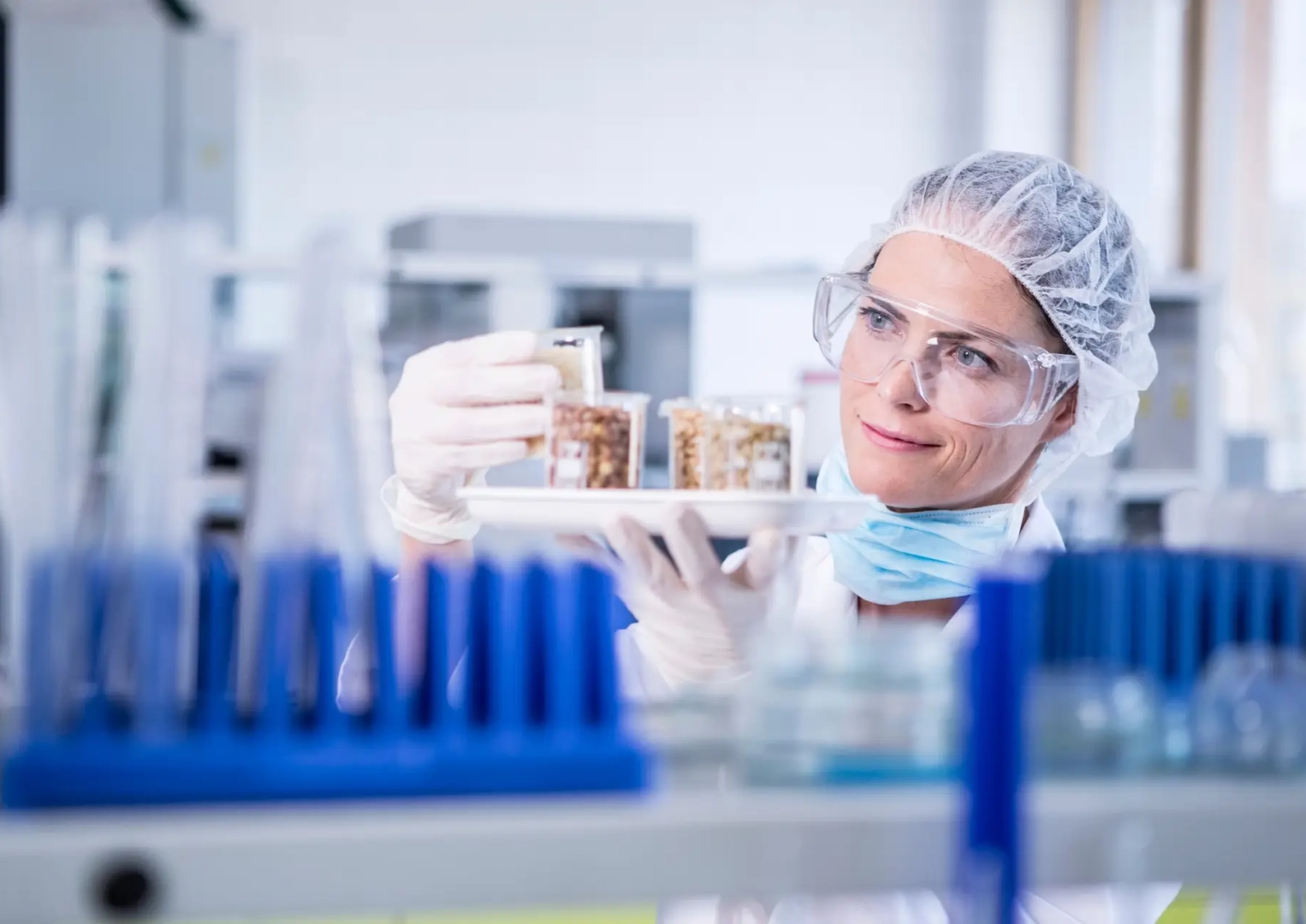 Scientist in lab examining seed samples