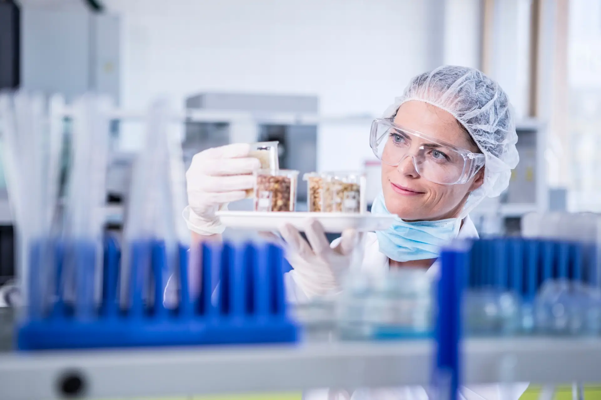 Scientist in lab examining seed samples